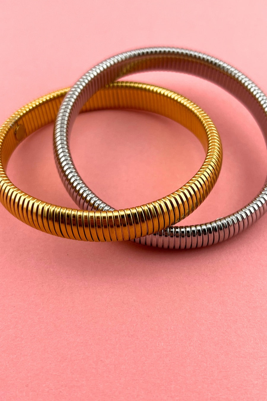 mixed metal bangle of gold and silver with an intertwined design