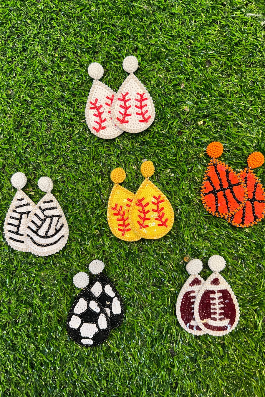 lightweight, sports-inspired beaded teardrop-shaped earrings with a felt backing, a comfort back, and a plastic disc stopper in gold that's nickel and lead compliant in baseball (white), basketball (orange), football (brown), soccer (black), softball (yellow), and volleyball (white)