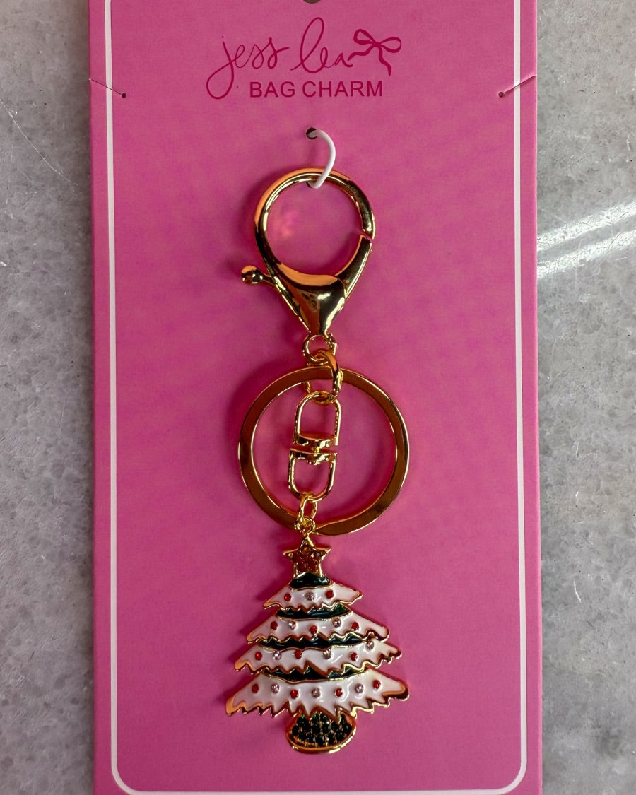 a festive layered green enamel fir Christmas tree with snowy white detailing, sprinkled with red and crystal accents, and crowned with a shimmering gold star, complete with a gold-tone swivel clasp and matching keyring