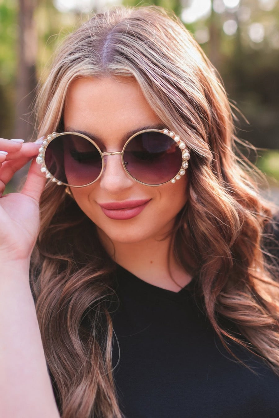 gold and black round sunglasses with scalloped edges and mixed-sized pearl trim around the frames, UV protection, and brand name detail (on both the temple and the complimentary black pouch)