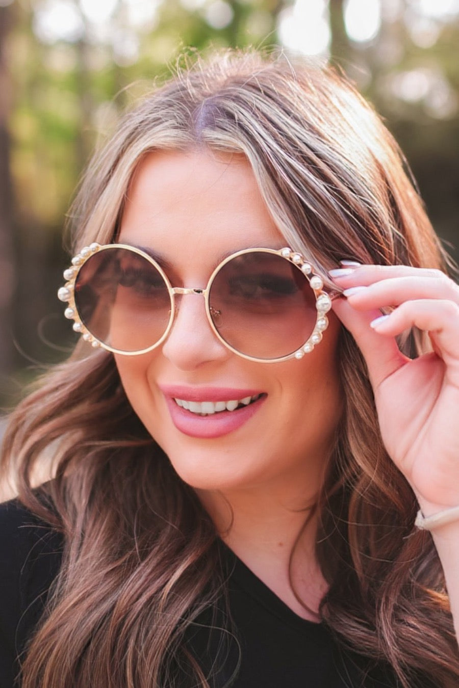 gold and brown round sunglasses with scalloped edges and mixed-sized pearl trim around the frames, UV protection, and brand name detail (on both the temple and the complimentary black pouch)