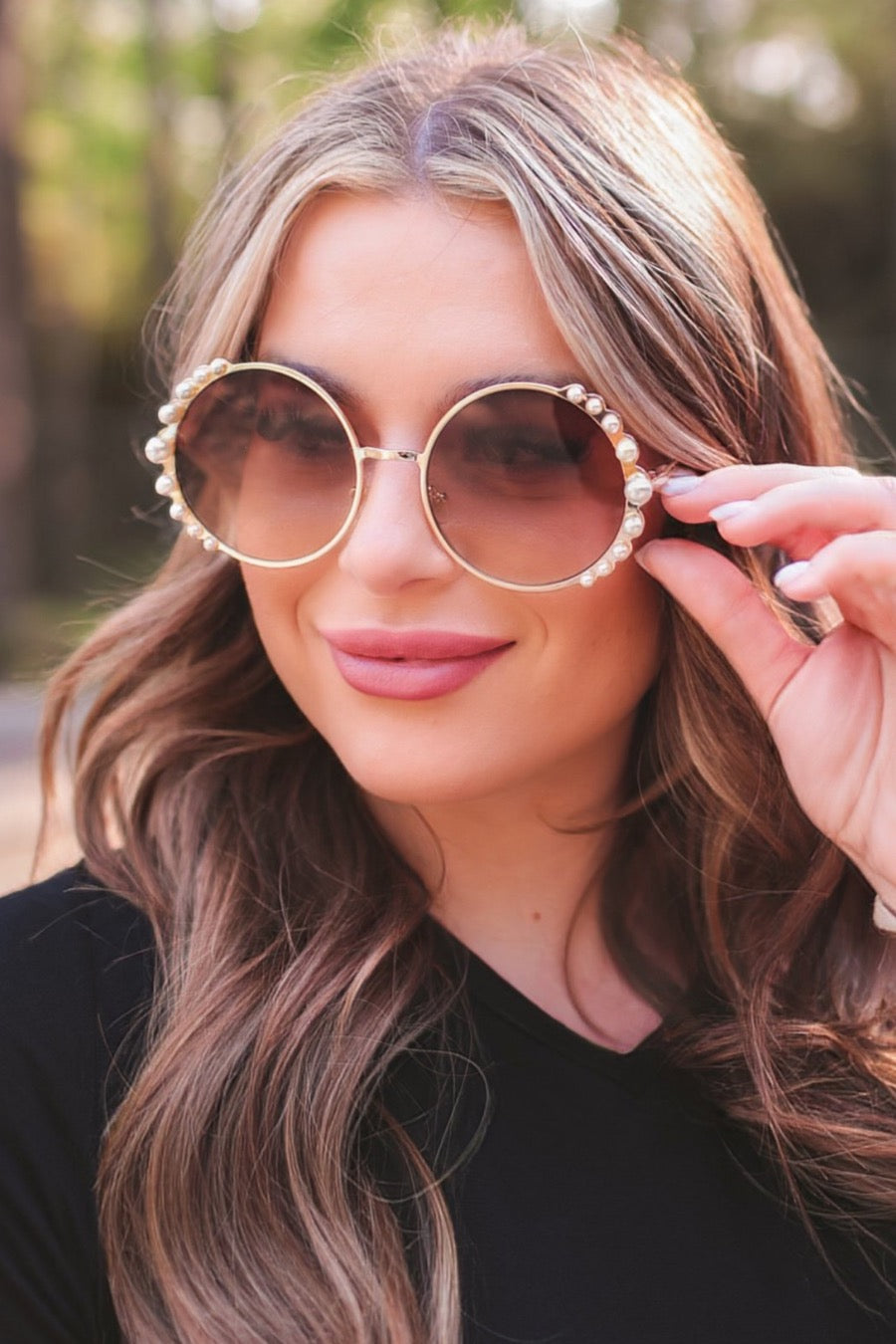 gold and brown round sunglasses with scalloped edges and mixed-sized pearl trim around the frames, UV protection, and brand name detail (on both the temple and the complimentary black pouch)