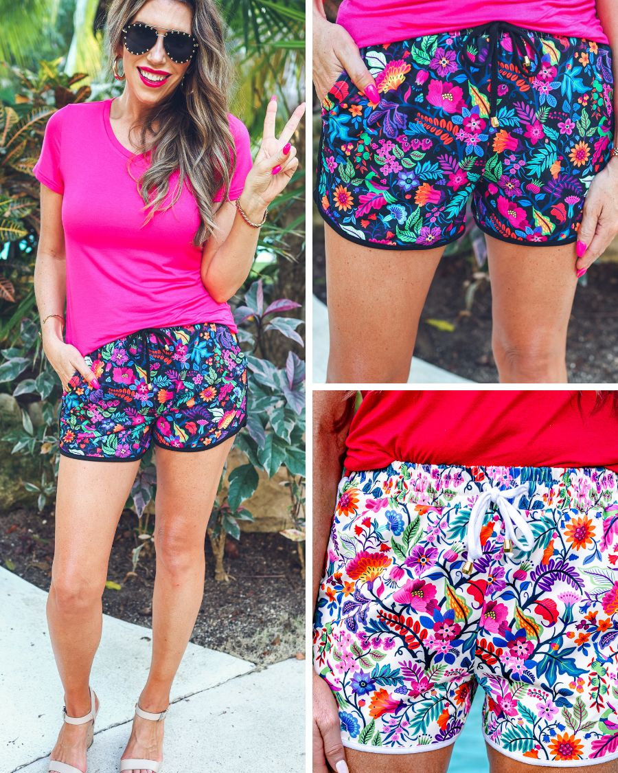 mid-rise relaxed fit activewear shorts with side pockets and a tie waist drawstring with gold bead accents, designed on a vibrant floral pattern print fabric, matching base, and matching trim