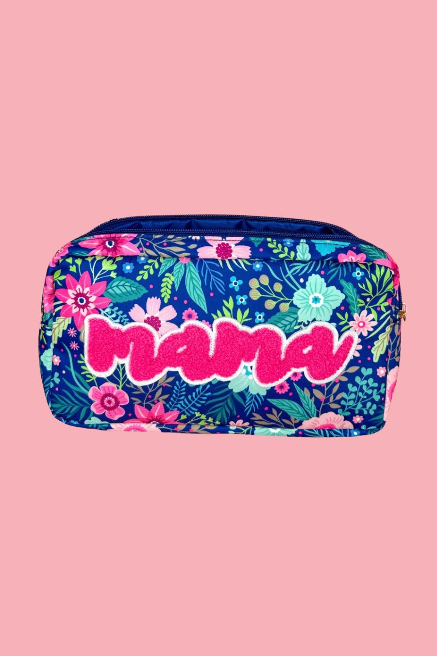 a lightweight spacious travel bag with a unique navy floral pattern (aqua, green, pink, and teal), a bold hot pink chenille 'mama' patch with white trim, and a zipper closer