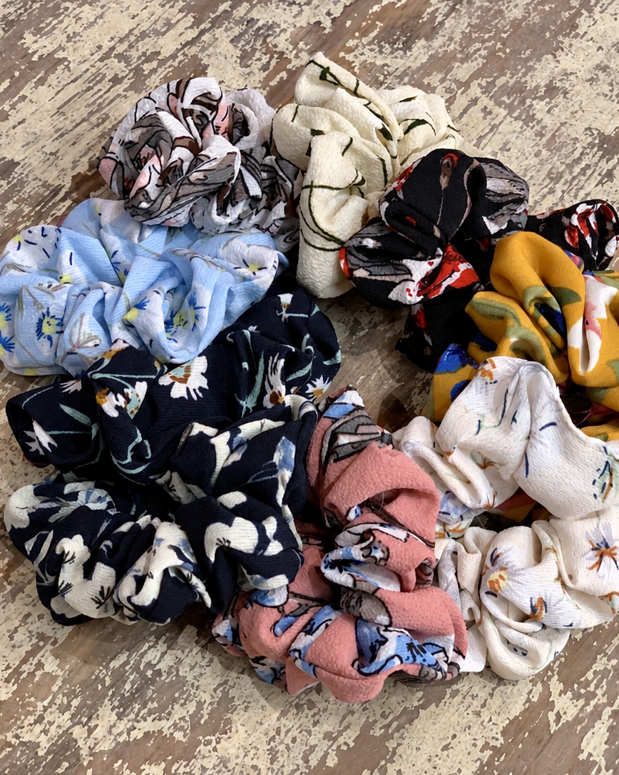 oversized floral scrunchies with lightweight textured fabric, gathered construction, gentle hair-friendly hold, and easy pull-on styling in banana, black, butterscotch, cream, mauve, navy cream, navy teal, sky, and white