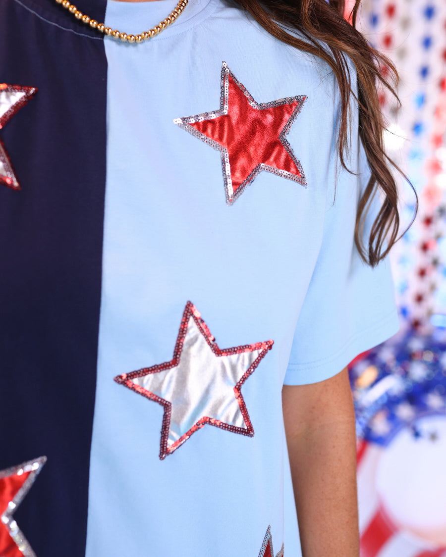 two-tone blue short-sleeved dress adorned with shimmering red and white foil stars outlined in coordinating sequins