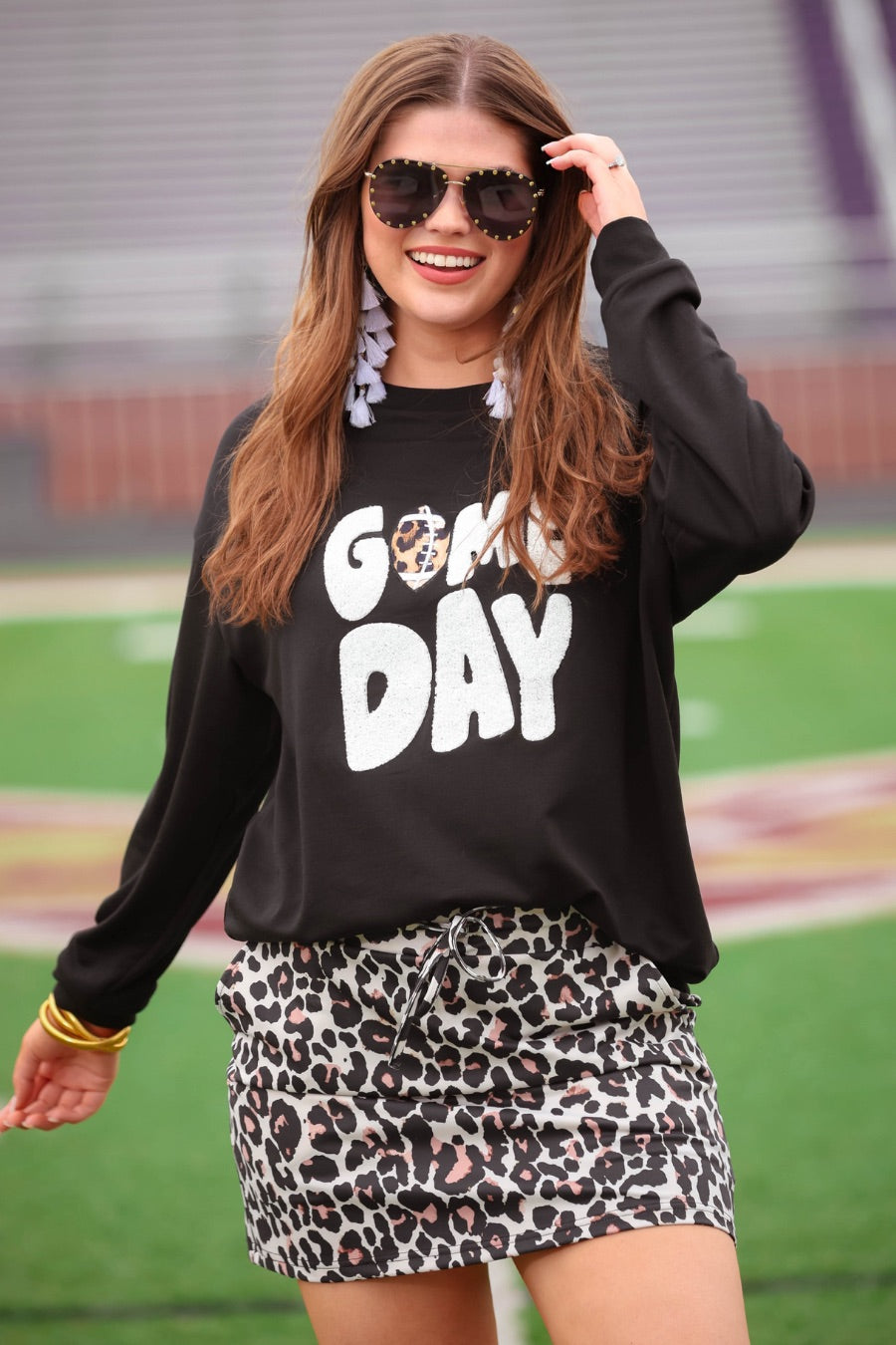 a black long-sleeve sweatshirt with standout "Game Day" chenille patch lettering in white and a leopard football detail as the A on an ultra-soft, midweight fabric