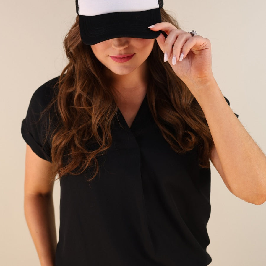 a lightweight black two-tone trucker hat with raised embroidered 'GAME DAY' lettering, tall foam front panel, breathable mesh back, snapback closure, and a curved bill