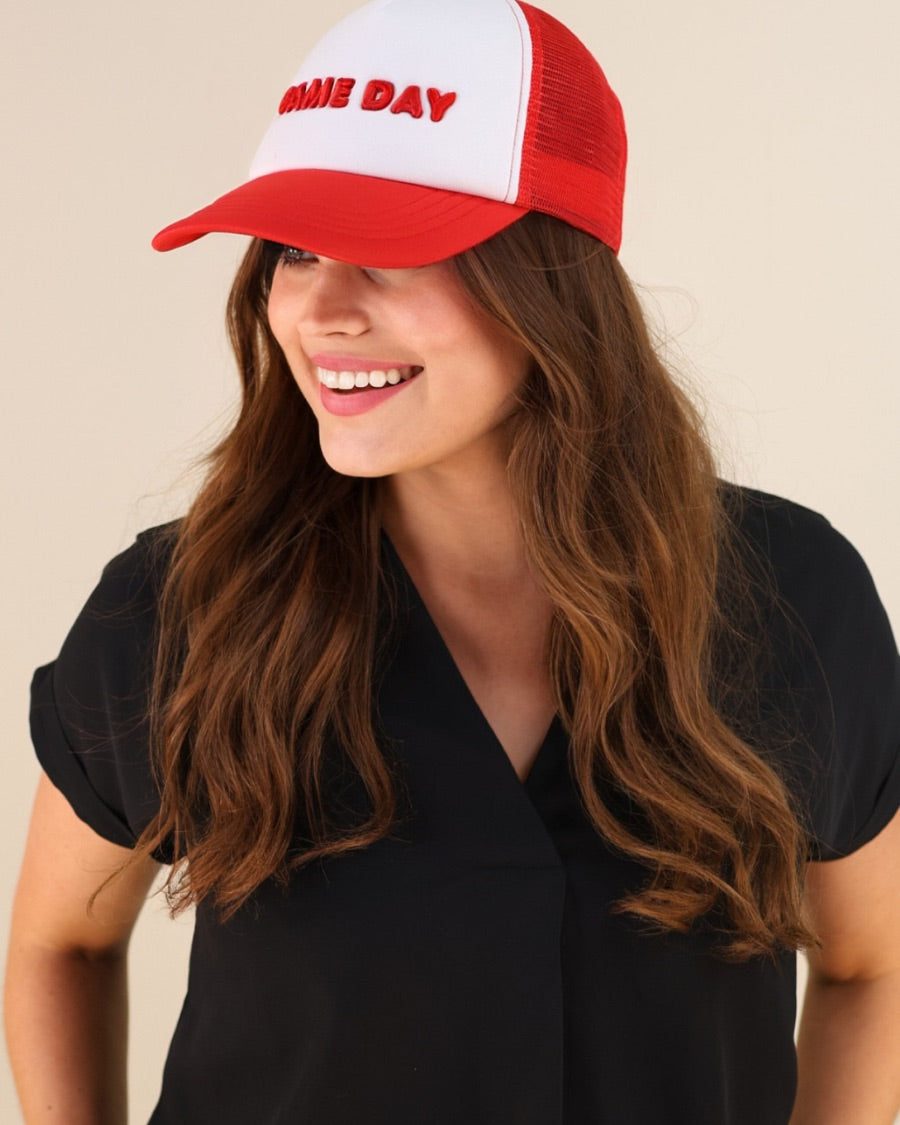 a lightweight red two-tone trucker hat with raised embroidered 'GAME DAY' lettering, tall foam front panel, breathable mesh back, snapback closure, and a curved bill