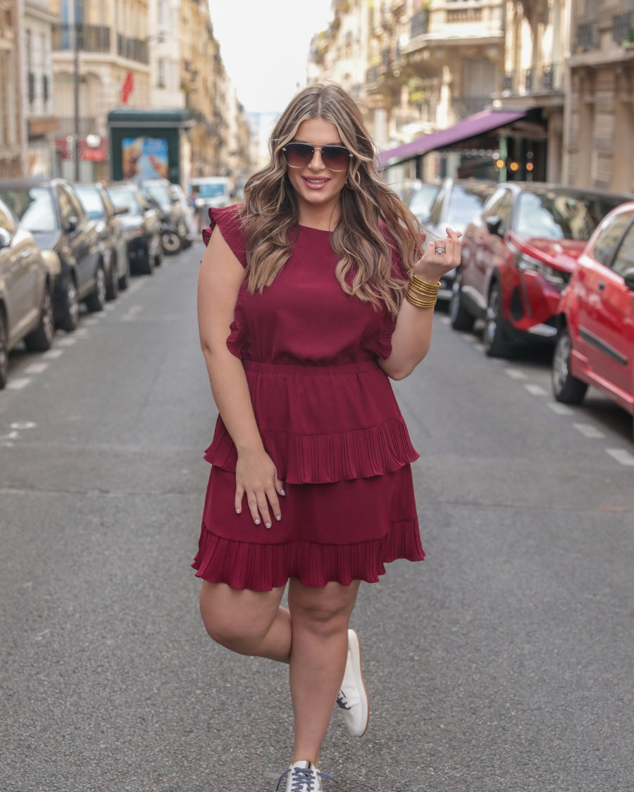 ruffled sleeve dress with layered pleats, an elastic waistband, and a lined bottom in burgundy