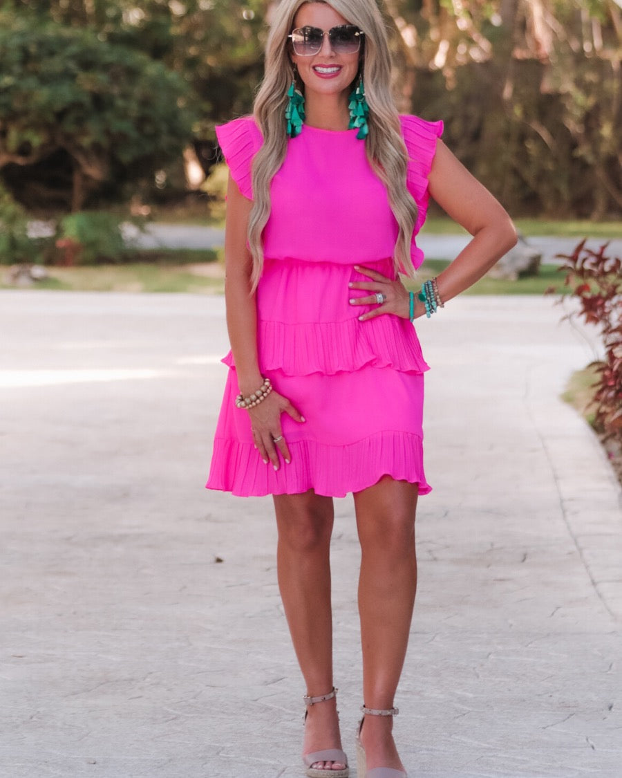 ruffled sleeve dress with layered pleats, an elastic waistband, and a lined bottom in pink