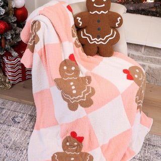 ultra soft, plush blanket with a custom-designed gingerbread girl pattern on a pink and white checkered fabric