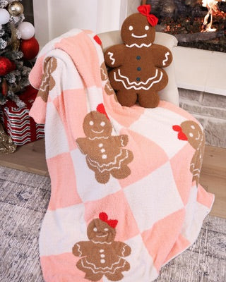 ultra soft, plush blanket with a custom-designed gingerbread girl pattern on a pink and white checkered fabric