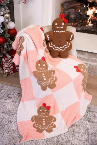 ultra soft, plush blanket with a custom-designed gingerbread girl pattern on a pink and white checkered fabric