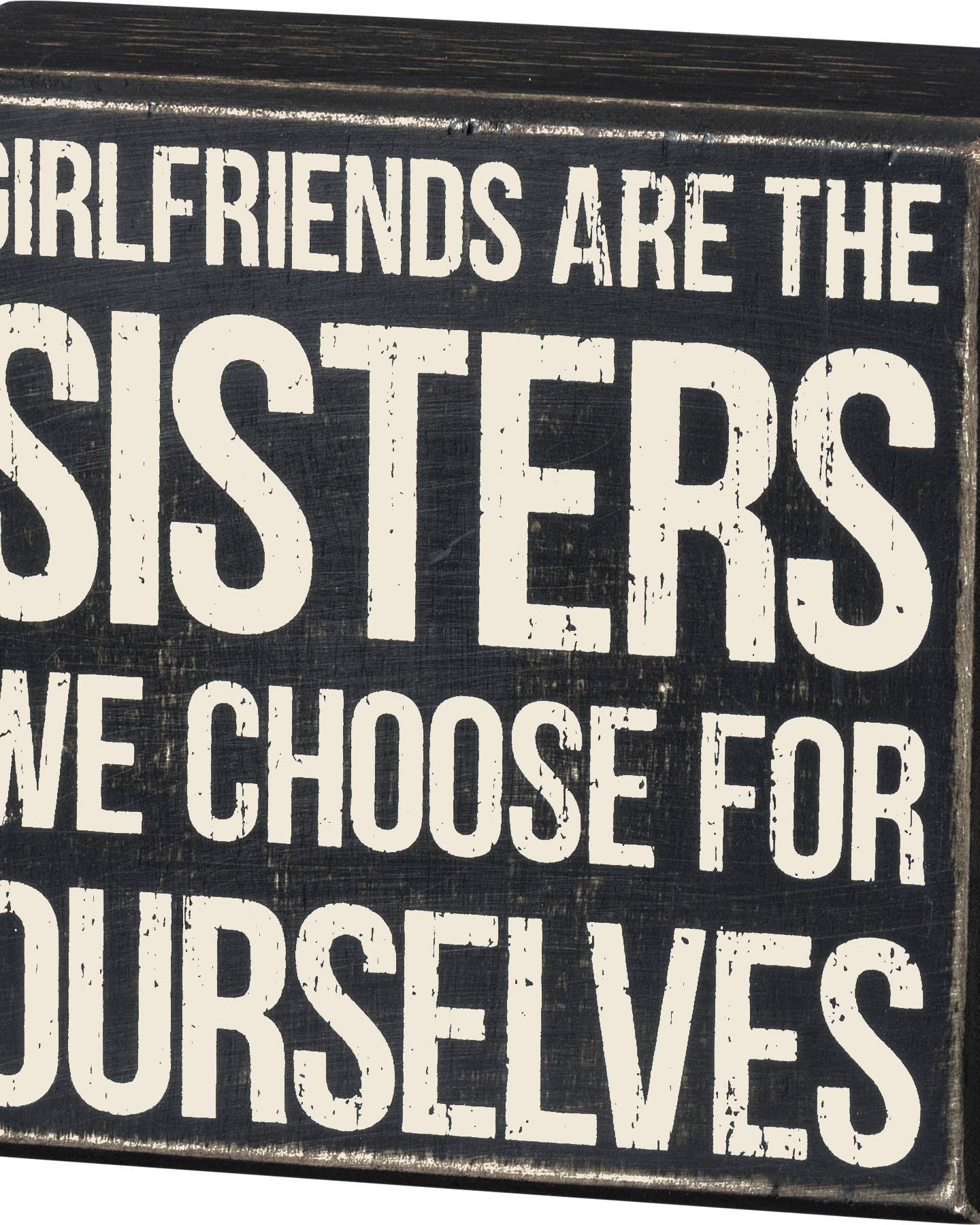 Black box sign with white text about girlfriends and sisters.