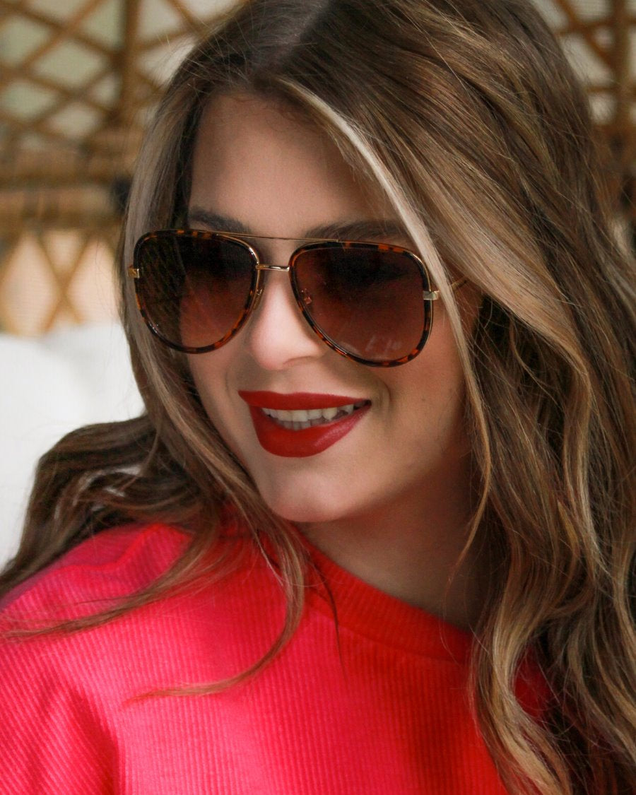 brown aviator sunglasses with thin round wireframes, tinted lenses, UV protection, and brand name detail (on both the temple and the complimentary black pouch)