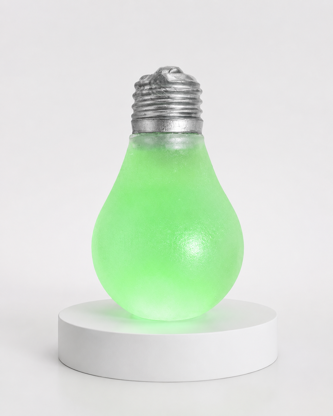 a glow-in-the-dark light bulb squishy with a frosted translucent body, metallic silver cap, soft squeezable texture, and classic bulb-inspired shape