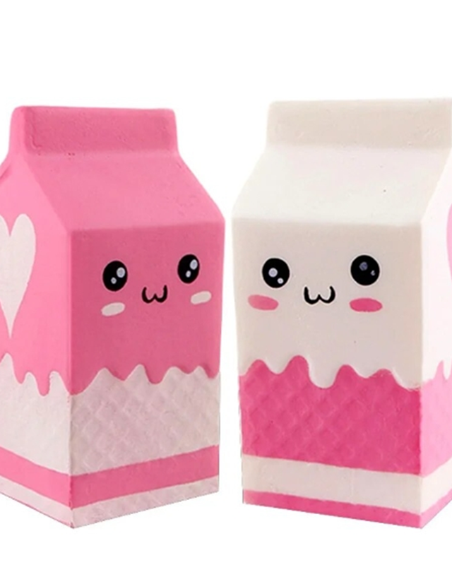 a milk-carton squishy with a kawaii face, pink-and-white colorblock design, textured accent panel, side heart detail, squeezable sensory feel, and individual packaging in pink and white