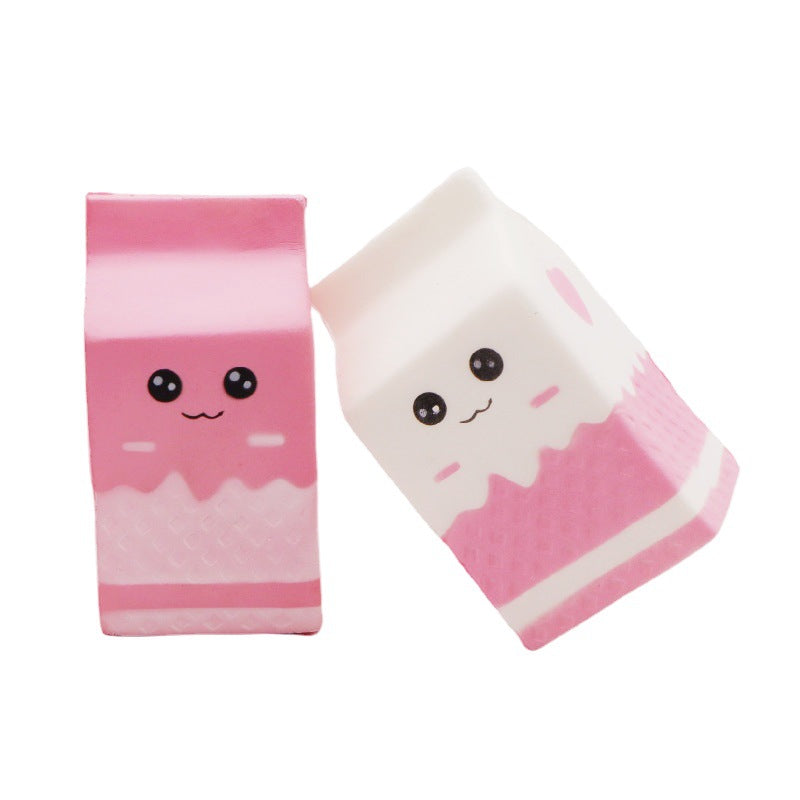pink and white milk-carton squishies with a kawaii face, pink-and-white colorblock design, textured accent panel, side heart detail, squeezable sensory feel, and clear individual packaging