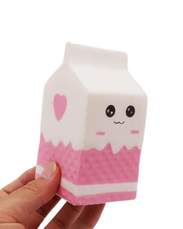 a white milk-carton squishy with a kawaii face, pink-and-white colorblock design, textured accent panel, side heart detail, squeezable sensory feel, and clear individual packaging