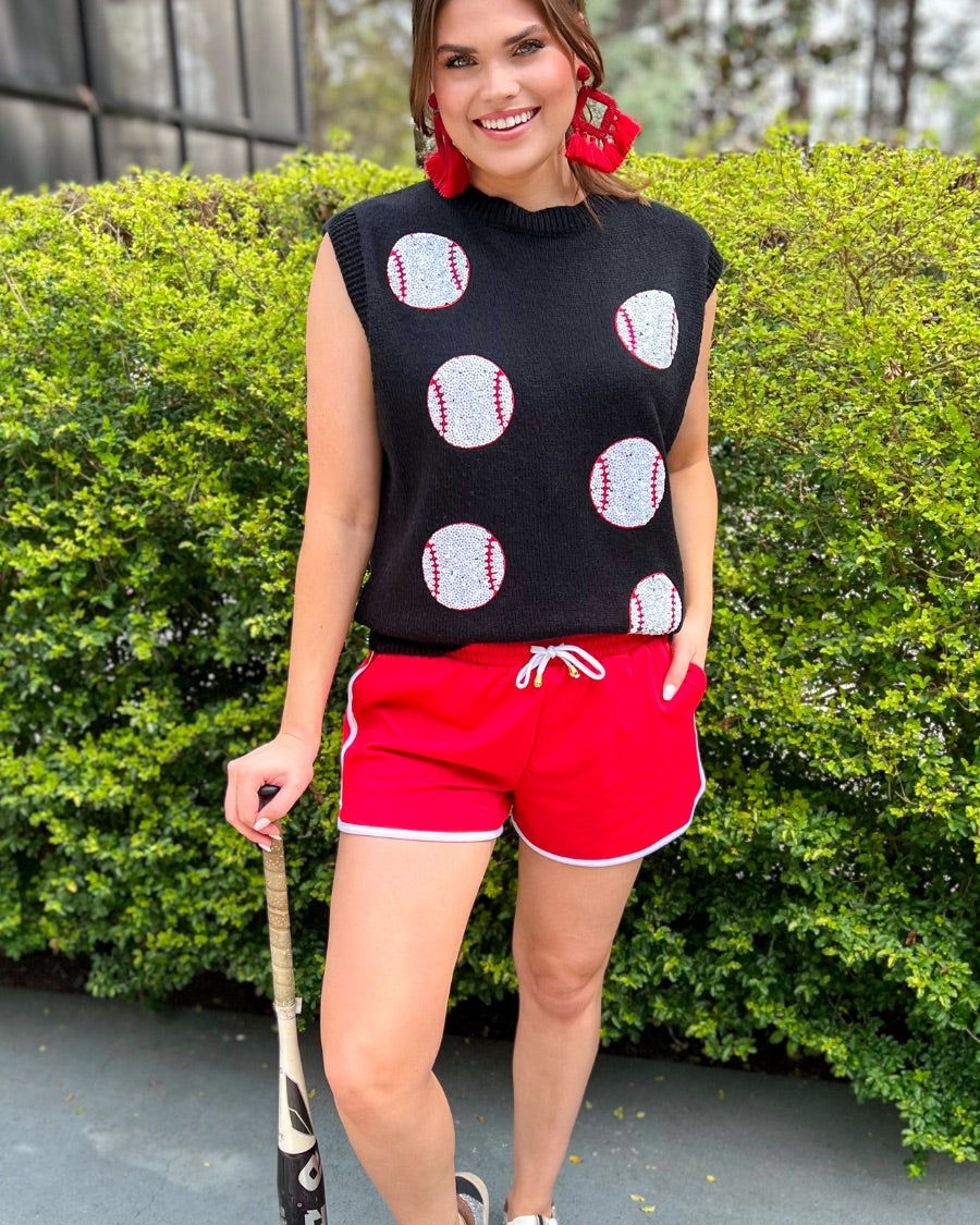 a black sleeveless sweater vest with an oversized fit, an allover textured baseball motif, and ribbed trim at the neckline, arm openings, and hem