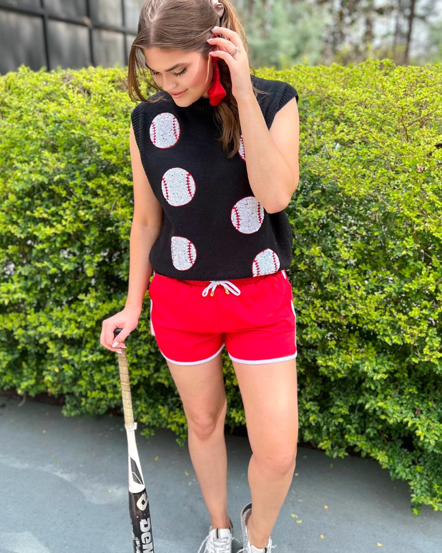 a black sleeveless sweater vest with an oversized fit, an allover textured baseball motif, and ribbed trim at the neckline, arm openings, and hem