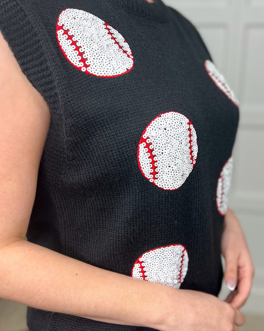 a black sleeveless sweater vest with an oversized fit, an allover textured baseball motif, and ribbed trim at the neckline, arm openings, and hem