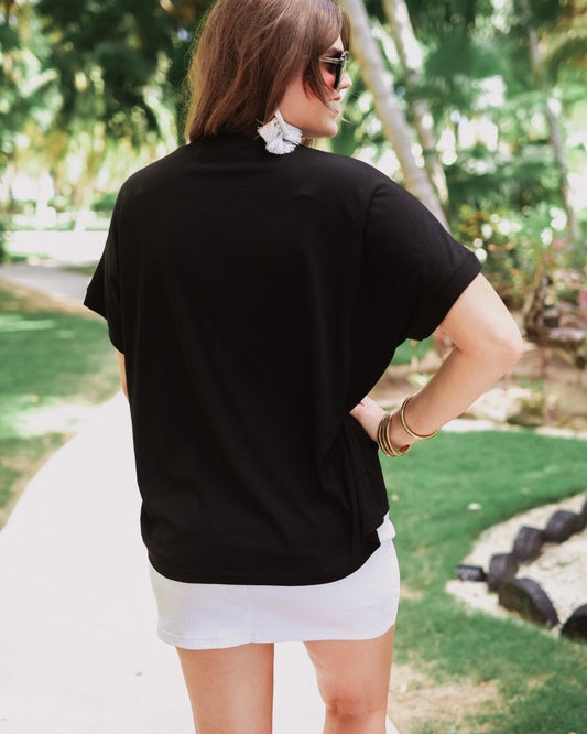 a black sleeveless sweater vest with an oversized fit, an allover textured baseball motif, and ribbed trim at the neckline, arm openings, and hem