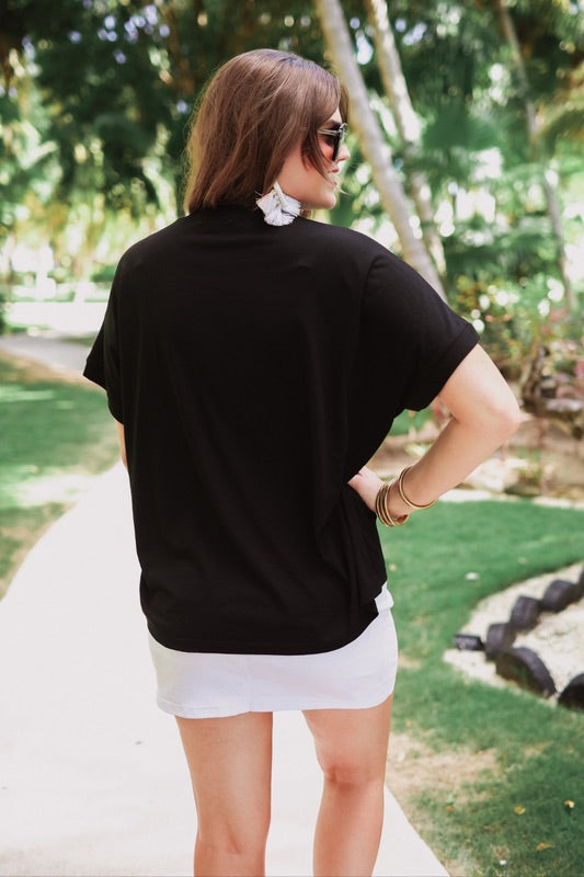a black sleeveless sweater vest with an oversized fit, an allover textured baseball motif, and ribbed trim at the neckline, arm openings, and hem