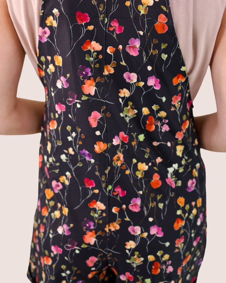 multicolor floral pattern print overall shorts on a black base made from our best-selling everyday fabric with functional button straps, a bib-style front, cuffed hems, roomy side pockets, and a realxed silhouette