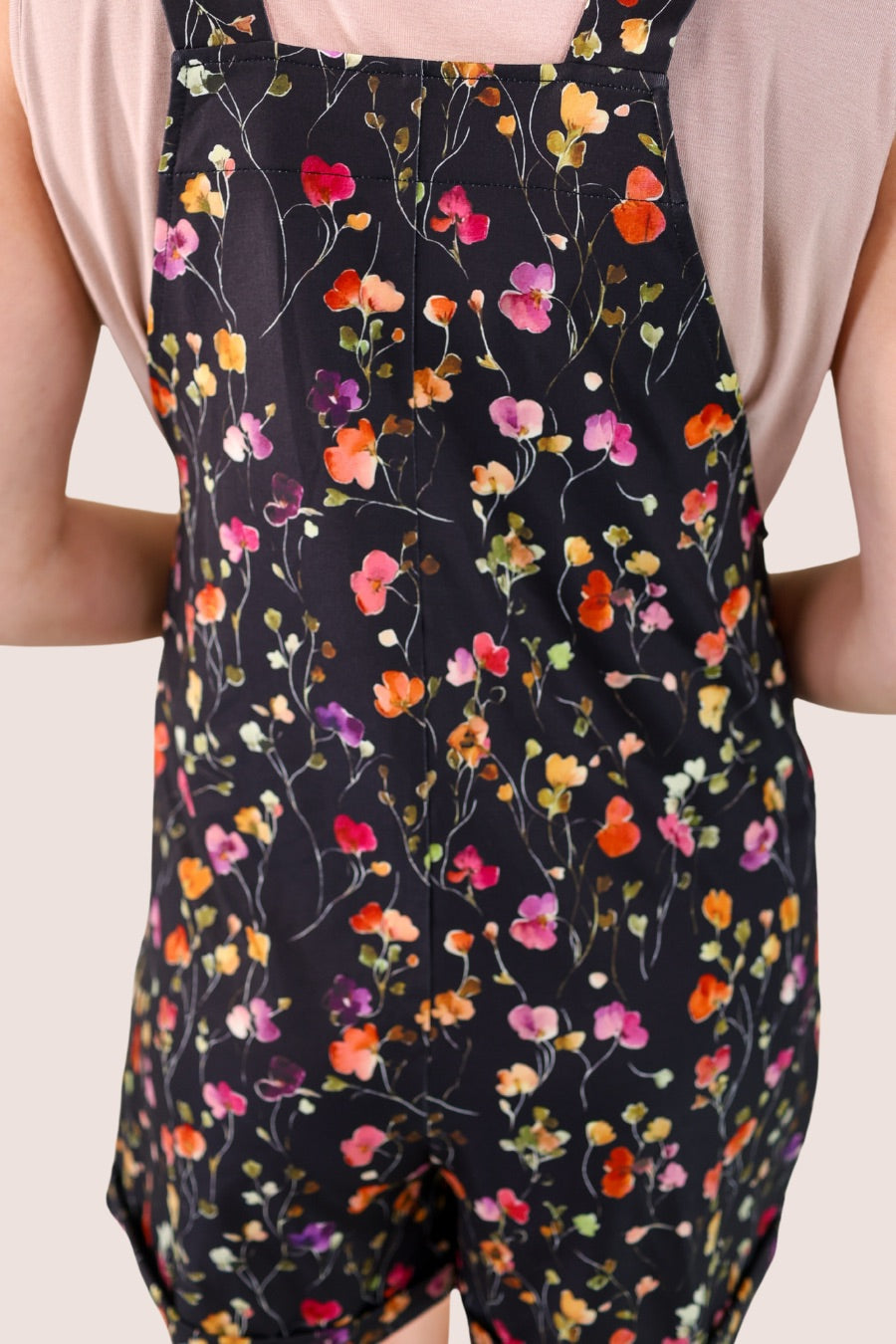 multicolor floral pattern print overall shorts on a black base made from our best-selling everyday fabric with functional button straps, a bib-style front, cuffed hems, roomy side pockets, and a relaxed silhouette