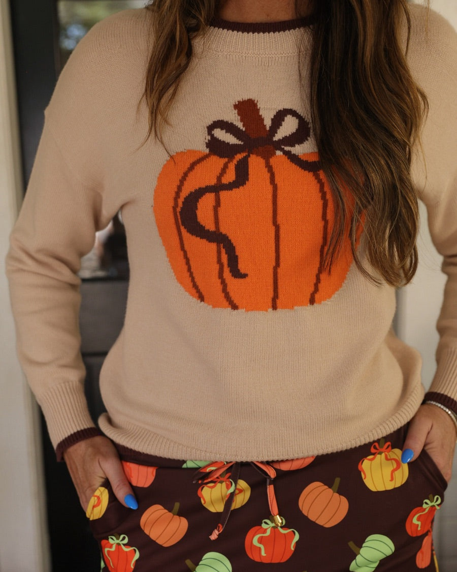 long-sleeve sweater with an oversized pumpkin, brown ribbed detailing (cuffs, neckline, and hem), and hem in brown, and a relaxed fit on a neutral base