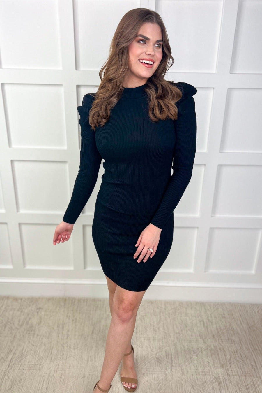 a mini bodycon dress with a flattering ribbed knit, long sleeves, a sophisticated mock neckline, and stylish puff sleeves in black