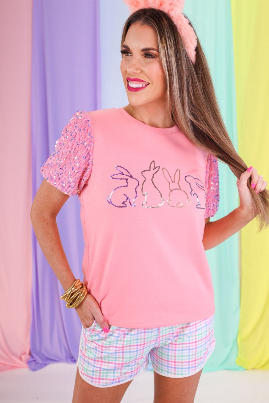 a soft velvet sequin sleeve top with four playful sequin bunny outlines on the front of a light pink fabric