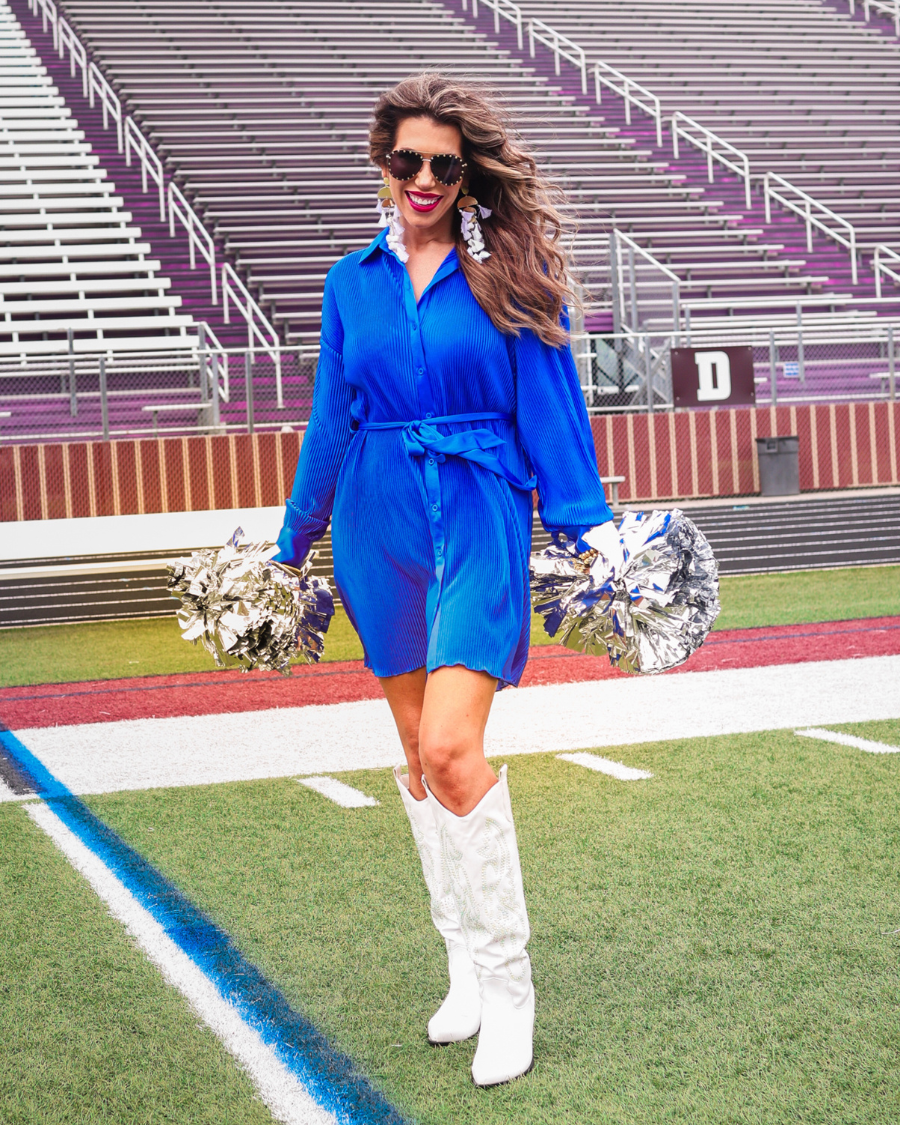 a royal blue pleated shirt dress with a classic collar, functional button front, removable waist sash, drop shoulder long sleeves, satin cuffs, back yoke seam, accordion texture, and flowy mini-length silhouette