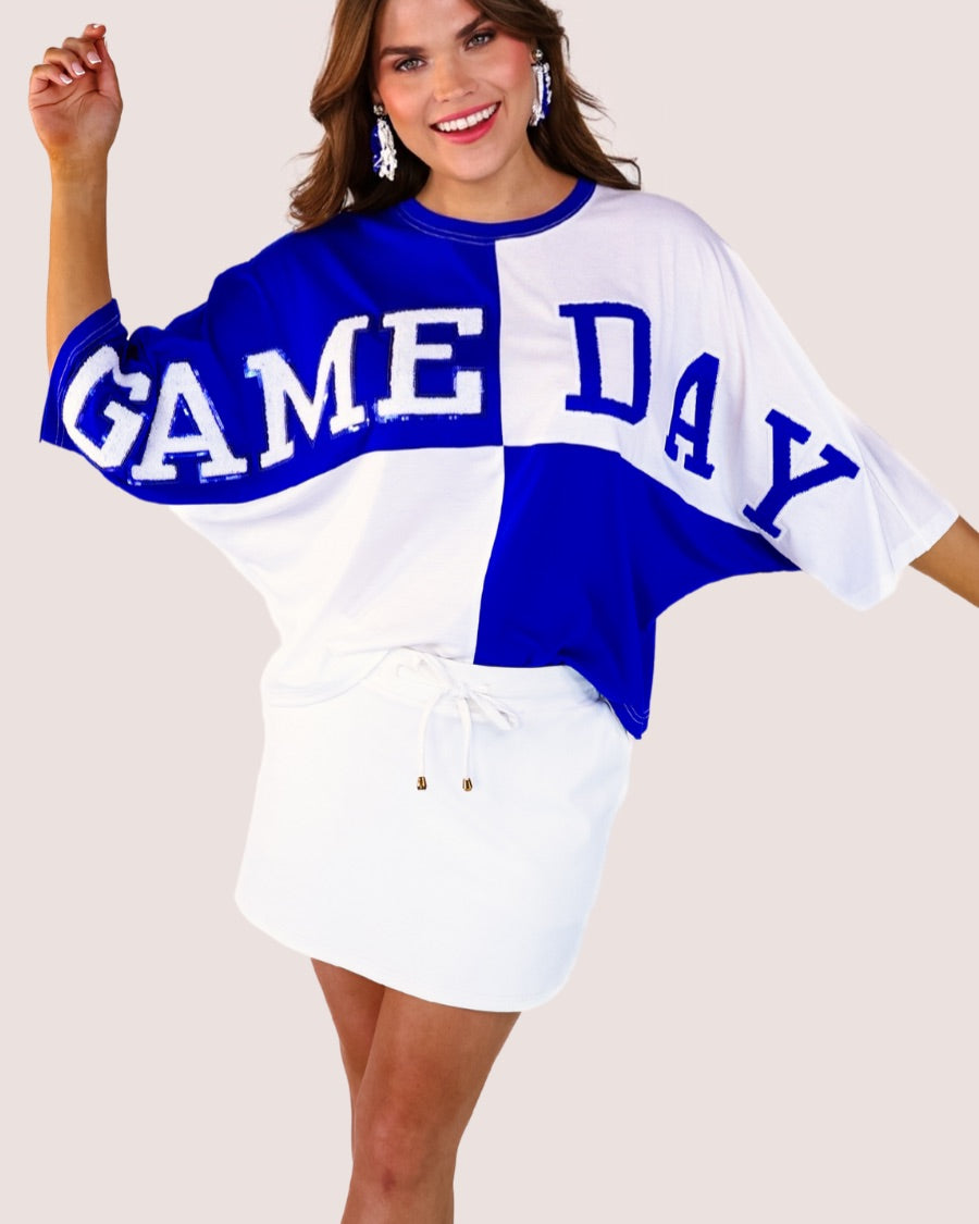 short-sleeve color block mom crop top with oversized chenille 'GAME DAY' lettering outlined in sequins, where GAME pops with a coordinating color outline to match the color block style, while DAY stands out with a crisp white outline in blue