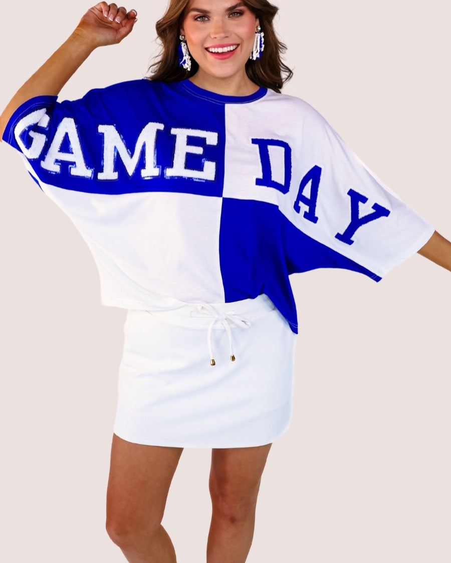 short-sleeve color block mom crop top with oversized chenille 'GAME DAY' lettering outlined in sequins, where GAME pops with a coordinating color outline to match the color block style, while DAY stands out with a crisp white outline in blue