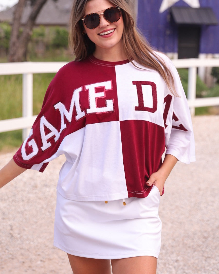 short-sleeve color block mom crop top with oversized chenille 'GAME DAY' lettering outlined in sequins, where GAME pops with a coordinating color outline to match the color block style, while DAY stands out with a crisp white outline in maroon