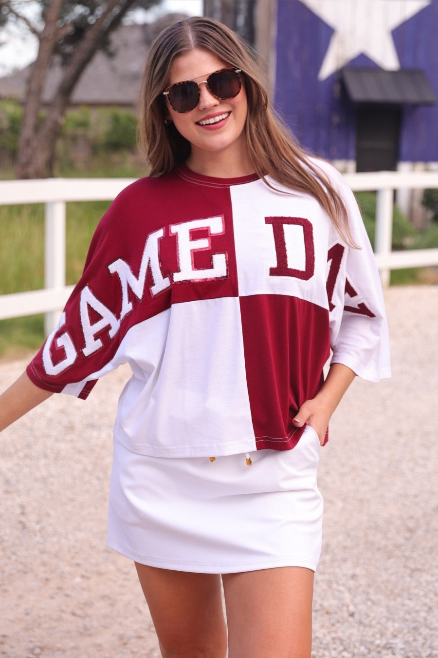 short-sleeve color block mom crop top with oversized chenille 'GAME DAY' lettering outlined in sequins, where GAME pops with a coordinating color outline to match the color block style, while DAY stands out with a crisp white outline in maroon