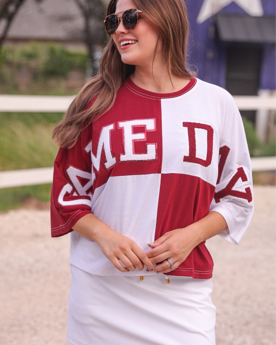 short-sleeve color block mom crop top with oversized chenille 'GAME DAY' lettering outlined in sequins, where GAME pops with a coordinating color outline to match the color block style, while DAY stands out with a crisp white outline in maroon