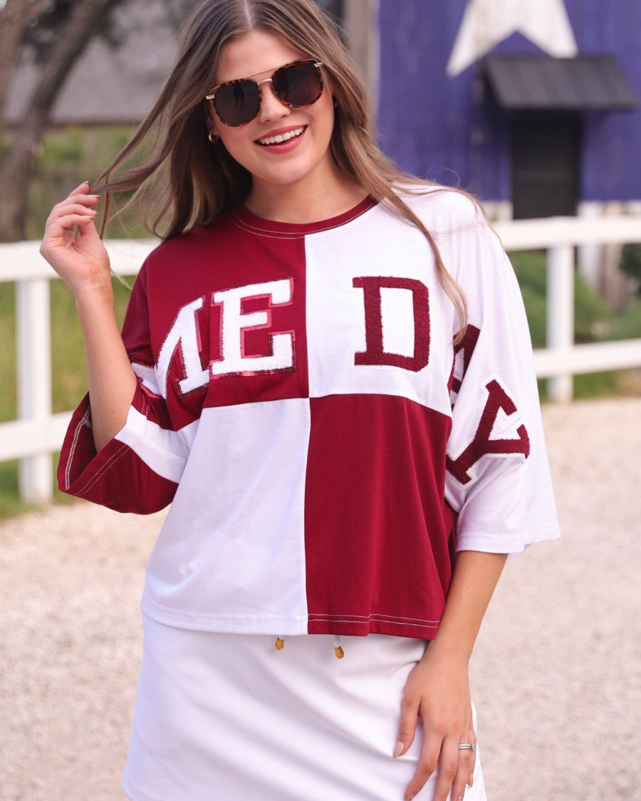 short-sleeve color block mom crop top with oversized chenille 'GAME DAY' lettering outlined in sequins, where GAME pops with a coordinating color outline to match the color block style, while DAY stands out with a crisp white outline in maroon