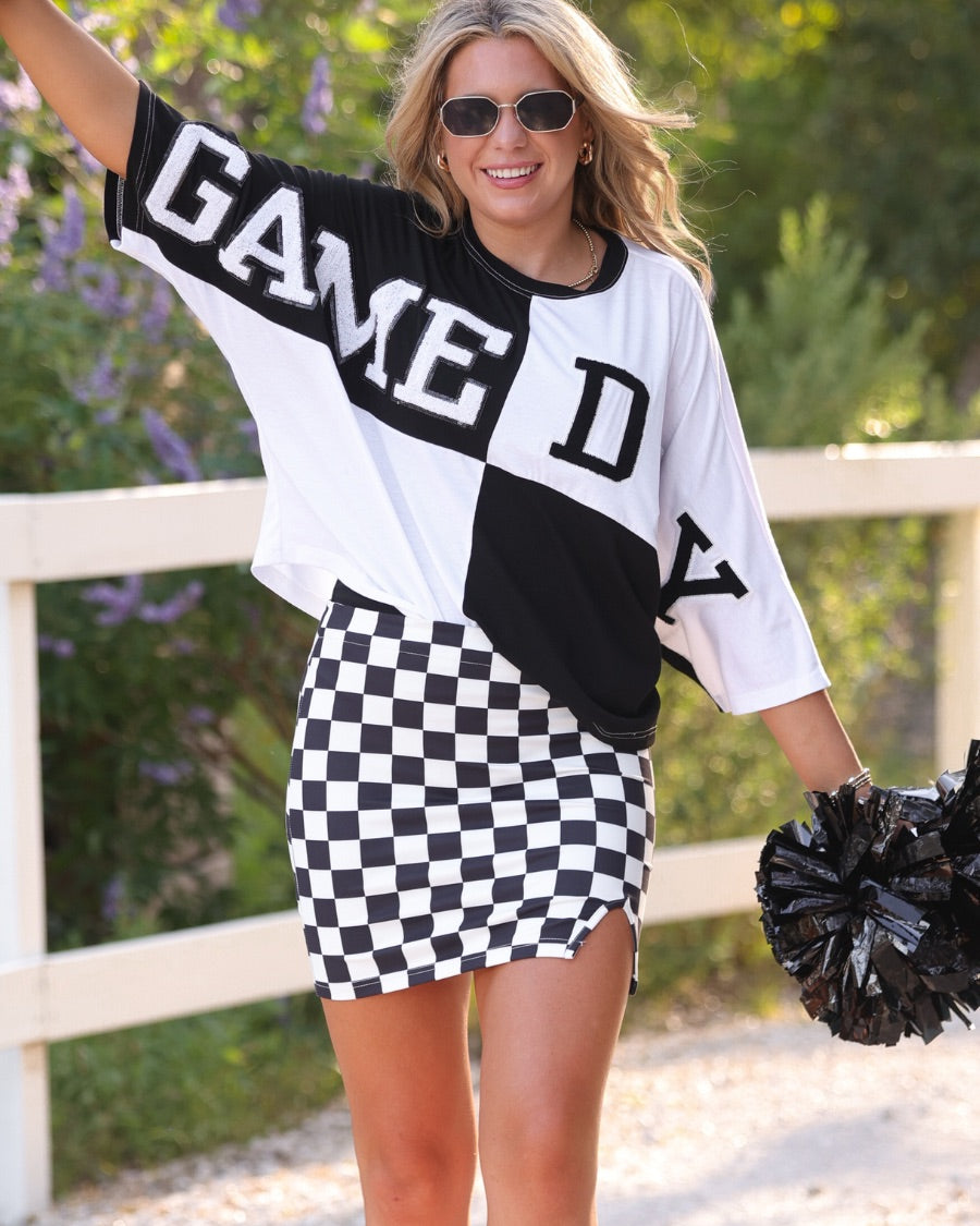 short-sleeve color block mom crop top with oversized chenille 'GAME DAY' lettering outlined in sequins, where GAME pops with a coordinating color outline to match the color block style, while DAY stands out with a crisp white outline in black