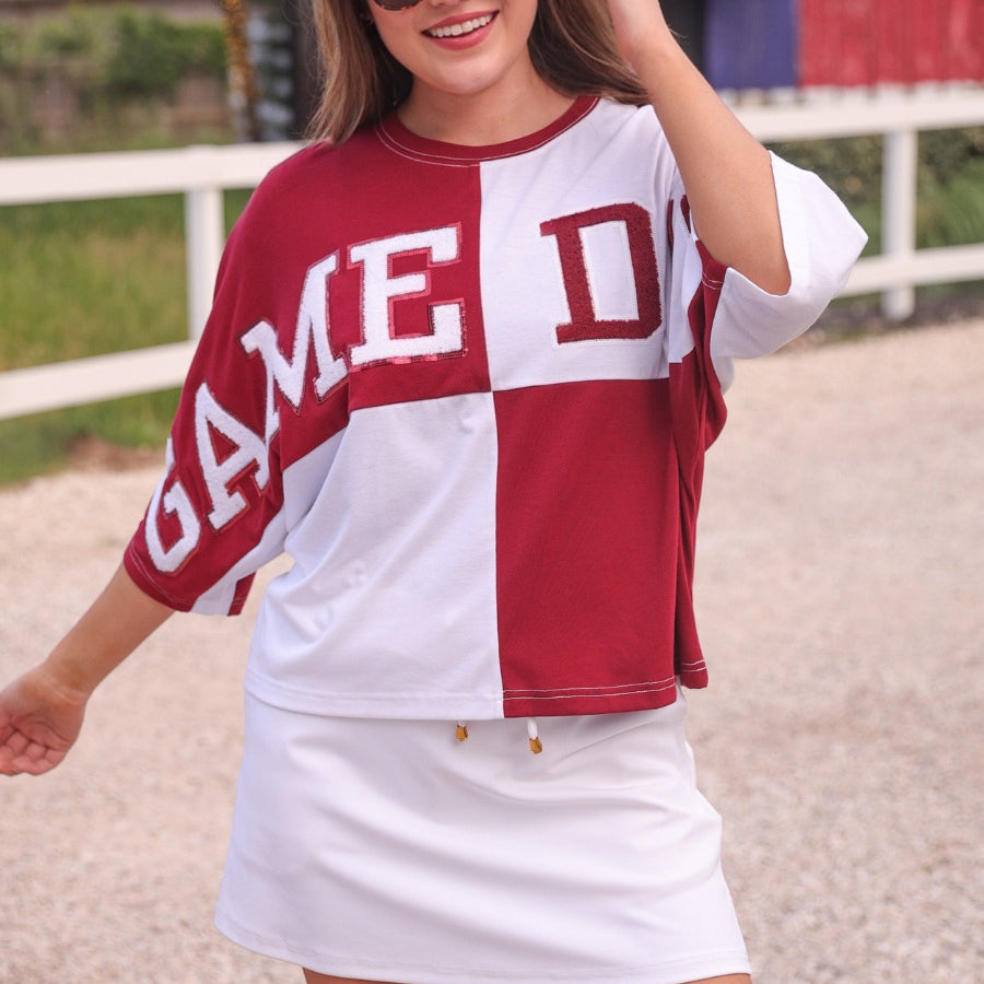 short-sleeve color block mom crop top with oversized chenille 'GAME DAY' lettering outlined in sequins, where GAME pops with a coordinating color outline to match the color block style, while DAY stands out with a crisp white outline in maroon