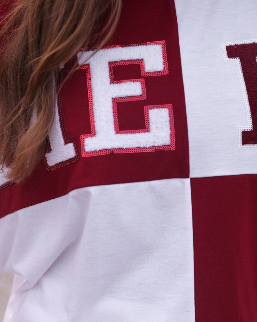 short-sleeve color block mom crop top with oversized chenille 'GAME DAY' lettering outlined in sequins, where GAME pops with a coordinating color outline to match the color block style, while DAY stands out with a crisp white outline in maroon