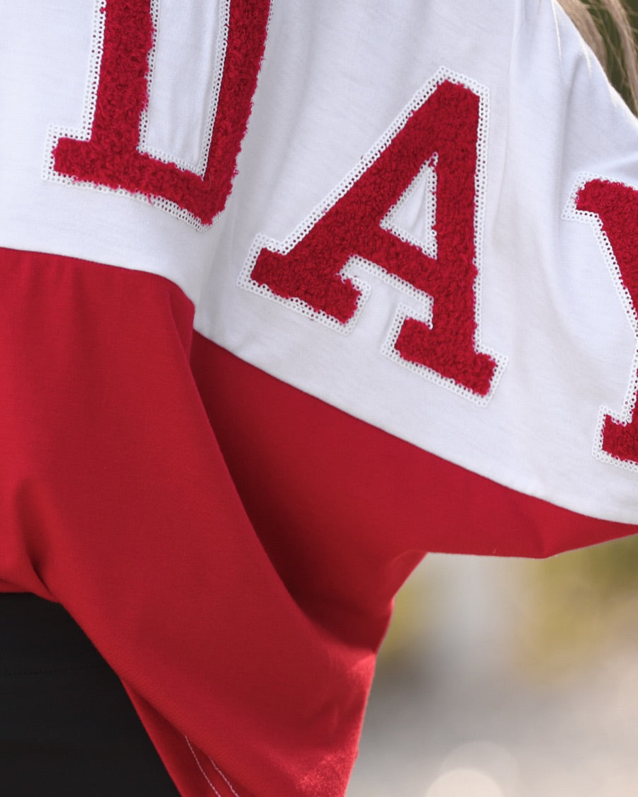 short-sleeve color block mom crop top with oversized chenille 'GAME DAY' lettering outlined in sequins, where GAME pops with a coordinating color outline to match the color block style, while DAY stands out with a crisp white outline in red