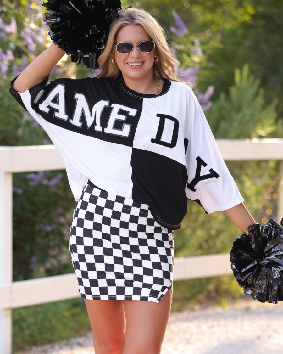 short-sleeve color block mom crop top with oversized chenille 'GAME DAY' lettering outlined in sequins, where GAME pops with a coordinating color outline to match the color block style, while DAY stands out with a crisp white outline in black