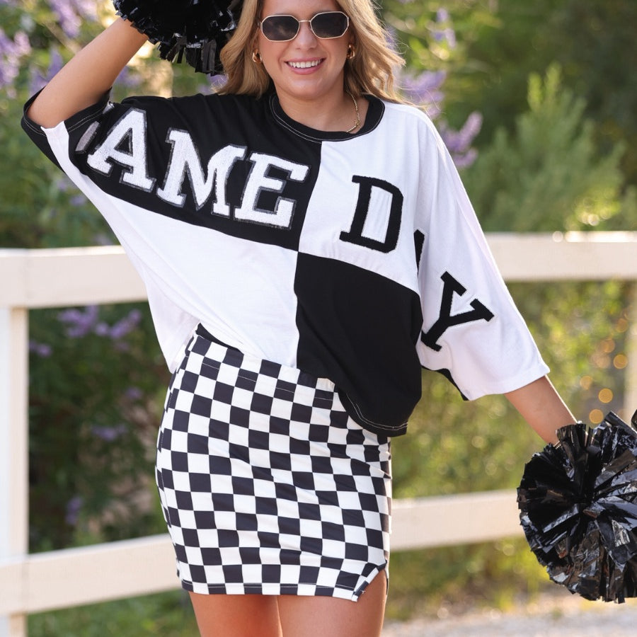 short-sleeve color block mom crop top with oversized chenille 'GAME DAY' lettering outlined in sequins, where GAME pops with a coordinating color outline to match the color block style, while DAY stands out with a crisp white outline in black