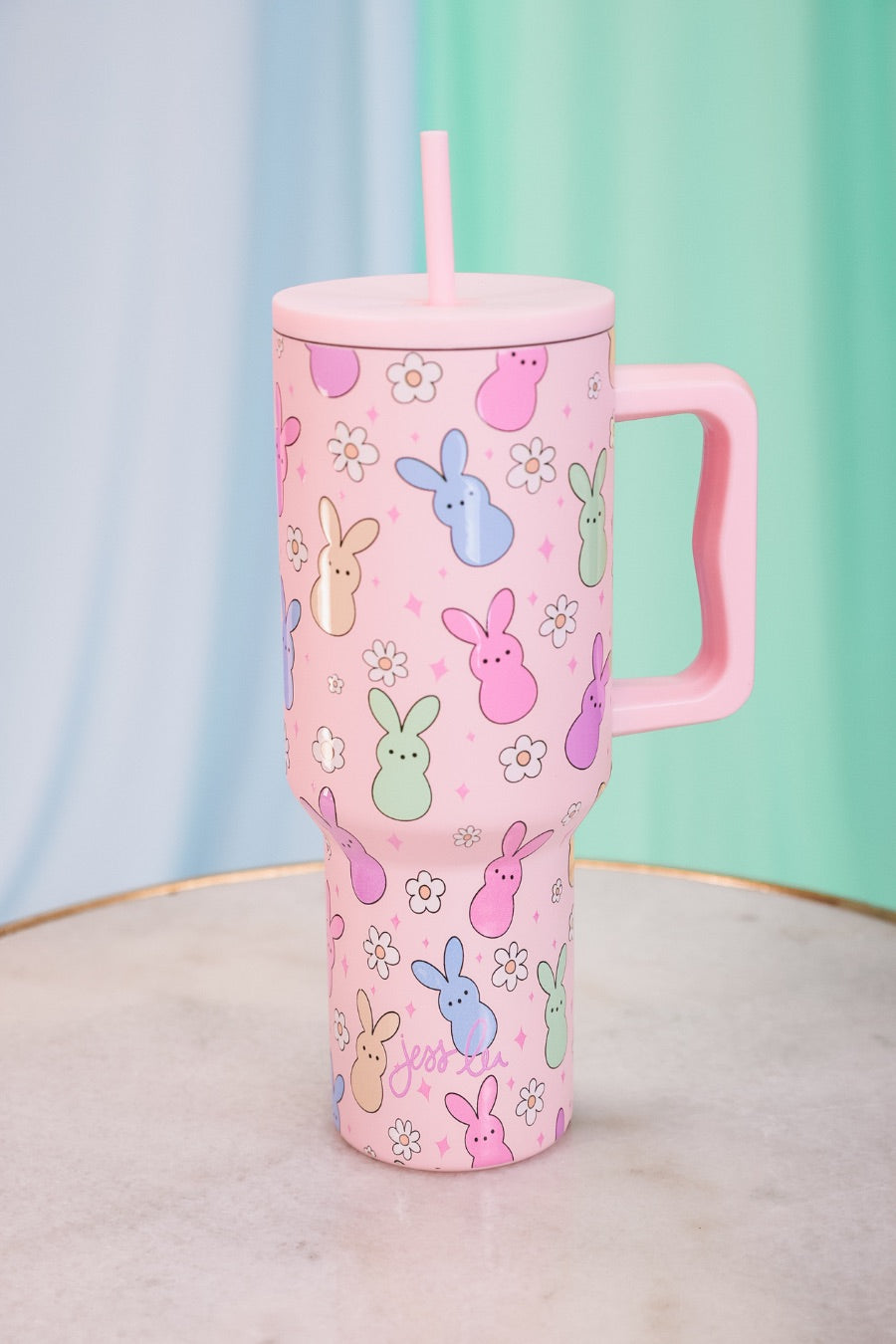 a 40-ounce tumbler with a charming bunny print design, handle, screw-on lid, and a reusable straw