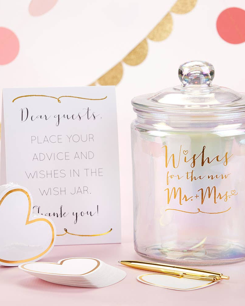Wish jar with a card and heart-shaped paper on a pink background