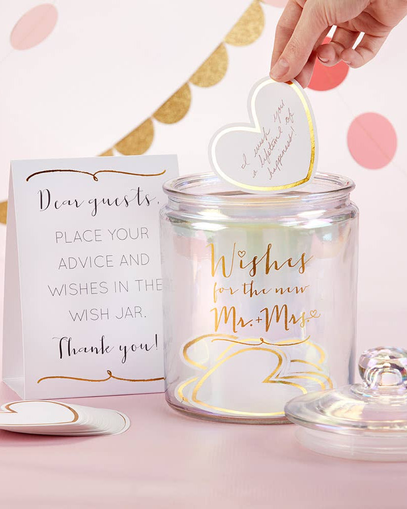 Wish jar with heart-shaped tag for wedding wishes on a pink background
